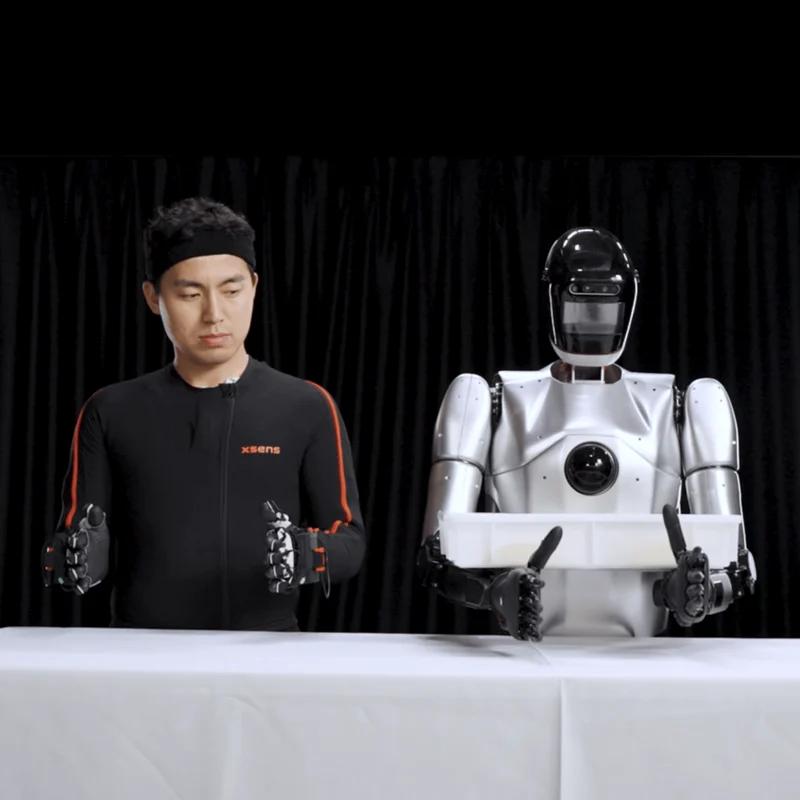 man in Xsens suit teleoperates robot